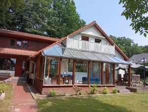 a house with large glass doors and a balcony at Homeland in Niederdorla