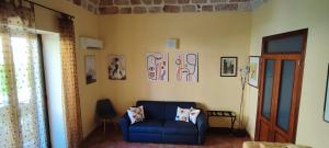 a living room with a blue couch in a room at casa Fontana in Capaci