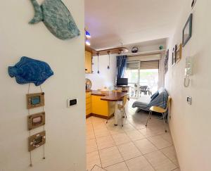 a kitchen and a living room with a fish on the wall at La Piccola Mimosa in Sestri Levante