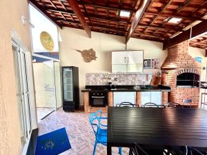 a kitchen with a table and chairs in a room at Casas CostaMar in Caraguatatuba