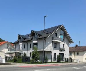 a large white building with a black roof at YAYstay - comfy Lofts in Rosenheim in Rosenheim +103 photos
