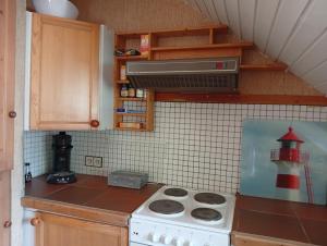 a kitchen with a stove top oven in a kitchen at Homeland in Niederdorla