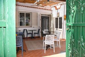 a patio with chairs and a table on a porch at Fantasy House Apartaments in Forio d'Ischia