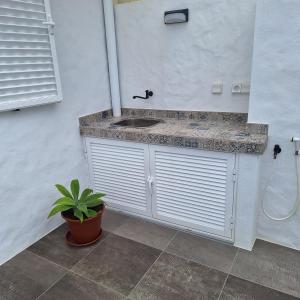 a bathroom with a sink and a shower at ALDABRA - CASA VACANZE EM PORTO SANTO in Porto Santo +39 photos