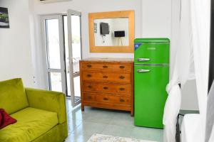 a living room with a green refrigerator and a dresser at Fantasy House Apartaments in Forio d'Ischia