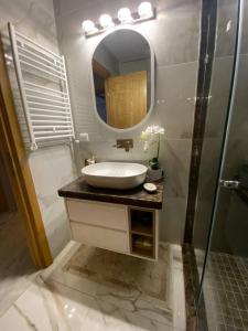 a bathroom with a sink and a mirror at Luxury Apartment two bedroom - sea view - best spot in sousse in Sousse +38 photos