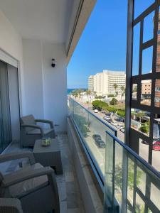 a balcony with chairs and a view of the ocean at Luxury Apartment two bedroom - sea view - best spot in sousse in Sousse