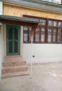 a front door of a building with a green door at Shaki Best house in Sheki