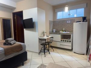 a small kitchen with a small table in a room at Casamar Lofts, Praia dos Anjos Arraial do Cabo in Arraial do Cabo +6 photos