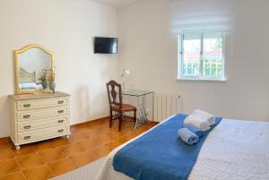 a bedroom with a bed and a dresser and a mirror at Paradise in Lagoa by DolceStay in Sesimbra
