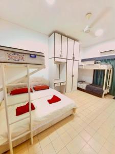 a bedroom with a bunk bed with red pillows at Condo by the Beach Port Dickson - Forest & Poolview in Port Dickson +27 photos