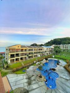 a resort with two pools and a building at Condo by the Beach Port Dickson - Forest & Poolview in Port Dickson