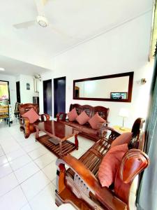 a living room with couches and a table at Condo by the Beach Port Dickson - Forest & Poolview in Port Dickson