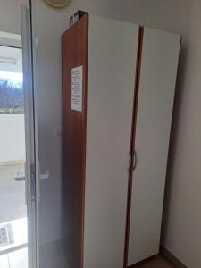 a door to a cabinet in a room at Studio Apartments Trio in Šmrika