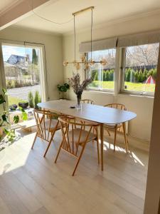 a dining room with a wooden table and chairs at Super family home - central location! in Oslo