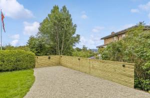 a retaining wall in front of a house at Super family home - central location! in Oslo