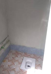 a bathroom stall with a toilet in the floor at Shaki Best house in Sheki +9 photos