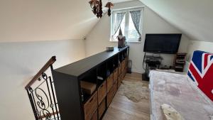 a living room with a crib and a television at Comfort Garden in Dunajská Streda