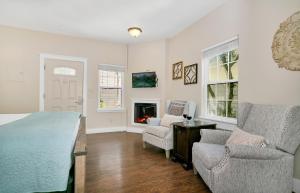 a bedroom with a bed and a couch and a fireplace at Main Street Retreat #2 - King Bed, On Main St, Shared Hot Tub & Pool in Fredericksburg