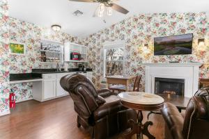 a living room with chairs and a fireplace at Main Street Retreat #9 - King Bed, On Main St, Shared Hot Tub & Pool in Fredericksburg