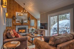 a living room with two couches and a fireplace at Modern Mtn Home*Pools*Fire Pit* in Campton