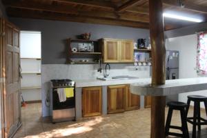 a kitchen with a sink and a stove top oven at Brisas del Caribe 3 in Tapantí