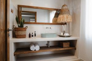 a bathroom with a sink and a mirror at Chic Elysium Bliss in Naxos Chora +32 photos