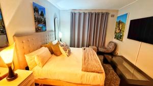 a bedroom with a bed and a chair in it at HOPE-always in Cape Town