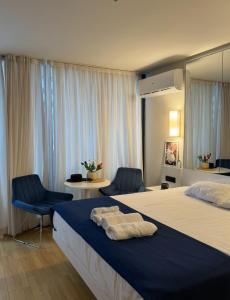 a hotel room with two beds and two chairs at Batumi Aparthotel In Orbi City 2025 in Batumi