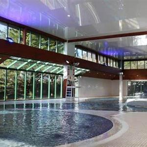 a large building with a swimming pool in front of it at Casita De Cuervo at Shorefield Park - WIFI - Pet Friendly - Passes Included in Everton