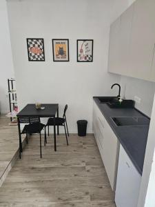 a kitchen with a table and a sink and a table at Cloud 9 Apartment in Lajkovići +24 photos