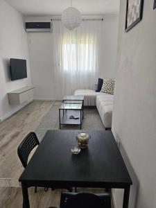 a living room with a table and a couch at Cloud 9 Apartment in Lajkovići