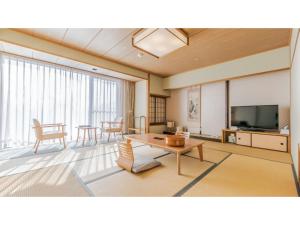 a living room with a table and a tv at Ouka no sato La-Foret Shobara - Vacation STAY 35117v in Shōbara