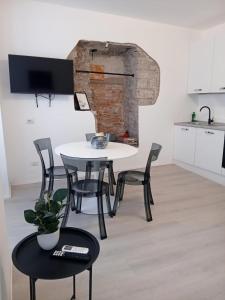 a table and chairs in a room with a kitchen at Piazza Roma apartment next como lake and station by revenue house in Como