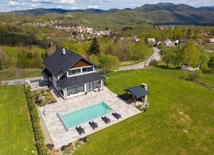 an aerial view of a house with a swimming pool at Villa ESEN - Fužine in Fužine