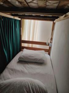 Ένα ή περισσότερα κρεβάτια σε δωμάτιο στο Palm Guesthouse