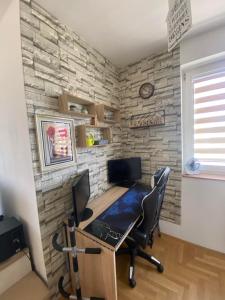 a room with a desk with a computer and chairs at Lake View EIA in Lukavica +6 photos