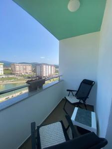 a room with two chairs and a table and a laptop at Lake View EIA in Lukavica