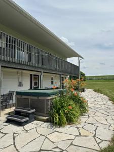 a patio with a pool table and a house at Mountain Ash Country Manor and Spa in Creemore