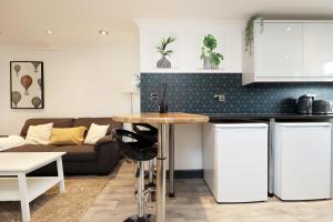 a kitchen with a table and a couch at Luxury Living, Central Spot in Cardiff +48 photos