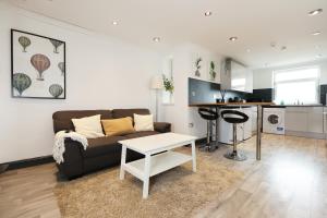 a living room with a couch and a table at Luxury Living, Central Spot in Cardiff