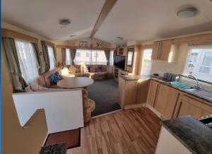 a kitchen and living room of an rv at Golden Palm - Meadow Lakes in Chapel Saint Leonards