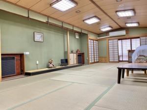 an empty room with a large room with a table and windows at Matsukisou"children under 6 years old not allowed" - Vacation STAY 36205v in Beppu +14 photos