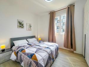 a bedroom with a bed and a window at Cozy Lagoon Apartment in Lezhë