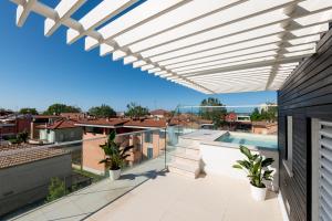 a view from the balcony of a house with a pergola at Rooftop Pool - VIP Penthouse in Fano