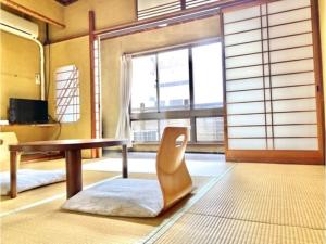 a living room with a table and a chair at Matsukisou"children under 6 years old not allowed" - Vacation STAY 36211v in Beppu +16 photos