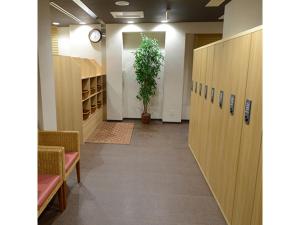 a hallway with wooden lockers and a potted plant at Midosuji Hotel - Vacation STAY 41579v in Osaka