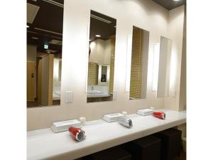 a bathroom with three sinks with mirrors and red handles at Midosuji Hotel - Vacation STAY 41579v in Osaka