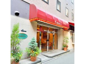 a store front with a red awning on a building at Midosuji Hotel - Vacation STAY 41579v in Osaka