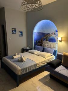 a bedroom with a bed and a large window at Victoria's Blue studios in Siviri